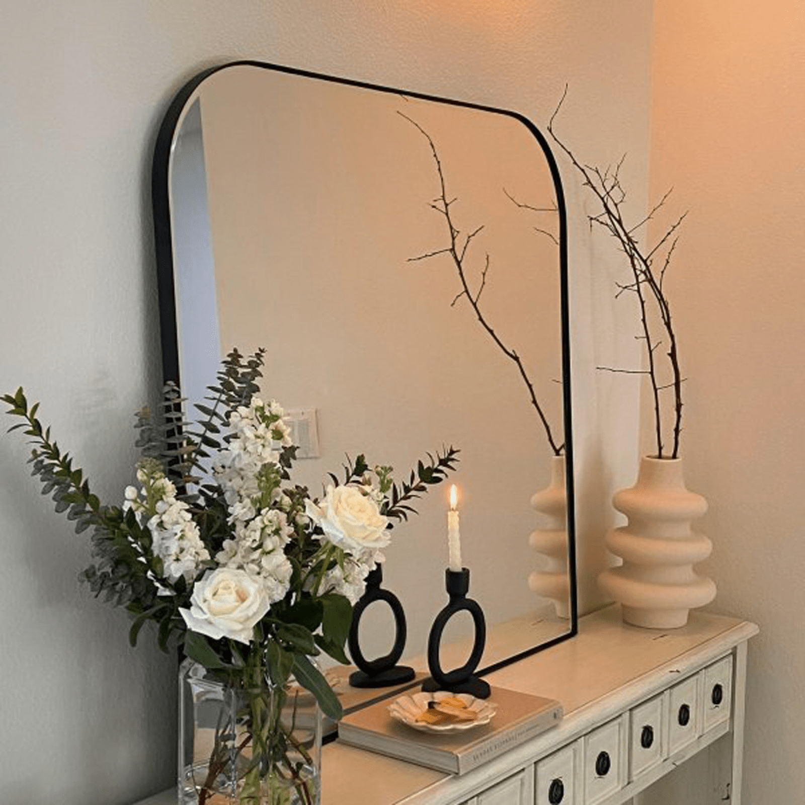 Bhargava modern black arch mantel mirror styled in a home interior | TEHOME